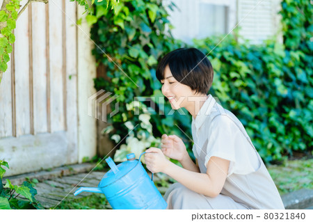 Young woman enjoying gardening Young woman enjoying gardening 80321840