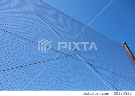 Baseball field back net blue sky 80323522