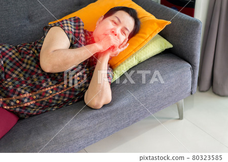 Elderly Asian woman coughing and lying on sofa at home,Female sore throat,Concept of health Elderly Asian woman coughing and lying on sofa at home,Female sore throat,Concept of health 80323585
