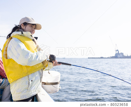 Young woman enjoying sea fishing 80323658