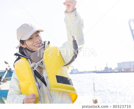 Young woman enjoying sea fishing 80323710