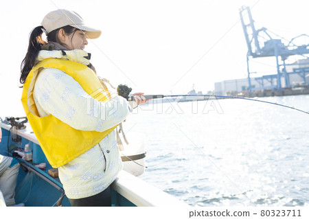 Young woman enjoying sea fishing 80323711