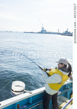 Young woman enjoying sea fishing 80323827