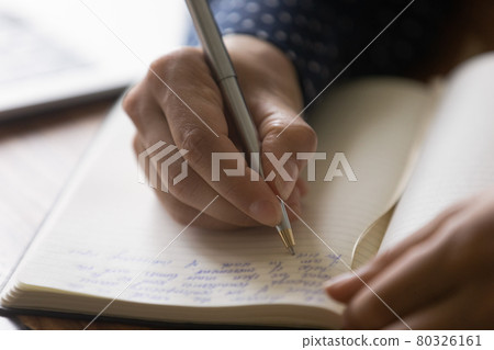 Hands of woman taking notes of online lecture webinar Hands of woman taking notes of online lecture webinar 80326161