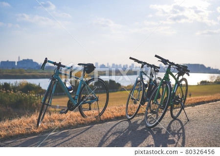 Bicycle touring on a riverbed on a sunny day Bicycle touring on a riverbed on a sunny day 80326456