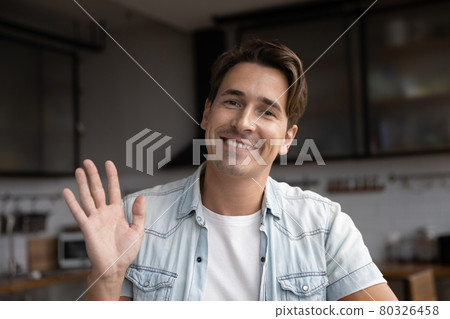 Young handsome man waving hand looking at camera. 80326458