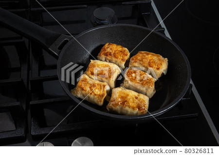 Few stuffed cabbage rolls fried on frying pan Few stuffed cabbage rolls fried on frying pan 80326811
