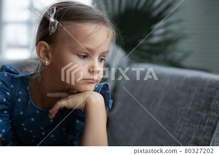 Unhappy little girl look in distance thinking Unhappy little girl look in distance thinking 80327202