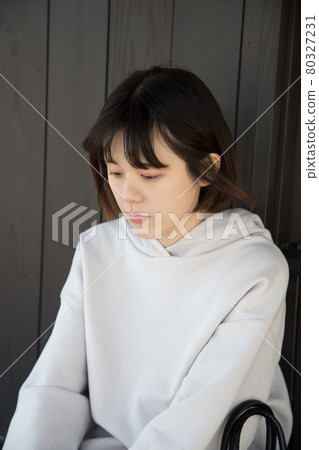 Woman sitting and looking down 80327231