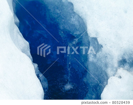 Crevasse and thaw water on the Perito Moreno Glacier in the Patagonia region of Argentina 80328439