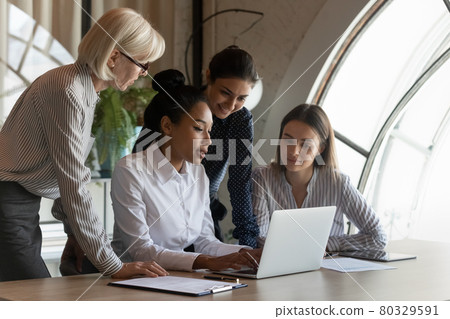 Confident young Asian professional presenting project to coworkers 80329591