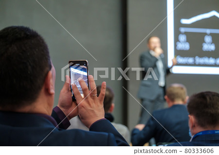Unrecognizable man shooting speaker during business seminar Unrecognizable man shooting speaker during business seminar 80333606