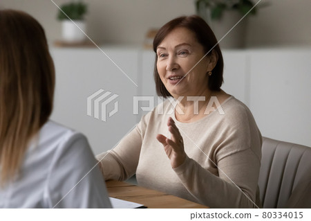 Positive elder patient visiting doctor, consulting about healthcare problems Positive elder patient visiting doctor, consulting about healthcare problems 80334015