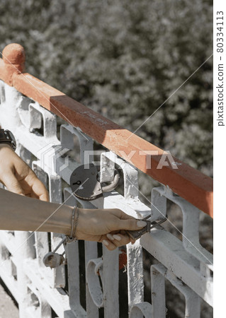 The bride and groom locks. Newlyweds hang the lock symbolizing everlasting love on the wedding day. 80334113