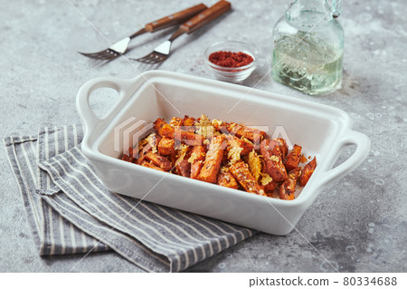 Sweet potato with cheese backed in bowl on grey background Sweet potato with cheese backed in bowl on grey background 80334688