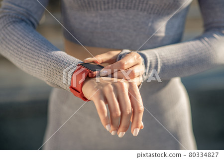 Close up picture of female hand with a smartwatch on it Close up picture of female hand with a smartwatch on it 80334827
