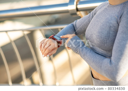 Close up picture of female hand with a smartwatch on it 80334830