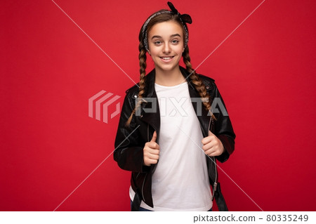 Photo shot of beautiful happy smiling brunette little girl with pigtails wearing trendy black Photo shot of beautiful happy smiling brunette little girl with pigtails wearing trendy black 80335249