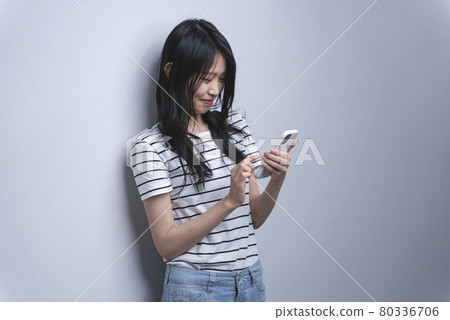 Woman using a smartphone Woman using a smartphone 80336706