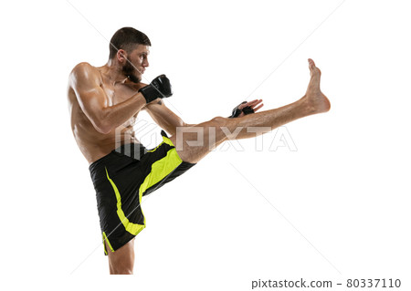 Professional male MMA boxer in motion isolated on white studio background. Fit muscular caucasian athlete fighting. Professional male MMA boxer in motion isolated on white studio background. Fit muscular caucasian athlete fighting. 80337110