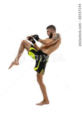 Professional male MMA boxer in motion isolated on white studio background. Fit muscular caucasian athlete fighting. Professional male MMA boxer in motion isolated on white studio background. Fit muscular caucasian athlete fighting. 80337144