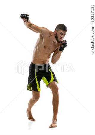 Portrait of professional male MMA boxer practicing isolated on white studio background. Fit muscular caucasian athlete fighting. Portrait of professional male MMA boxer practicing isolated on white studio background. Fit muscular caucasian athlete fighting. 80337183
