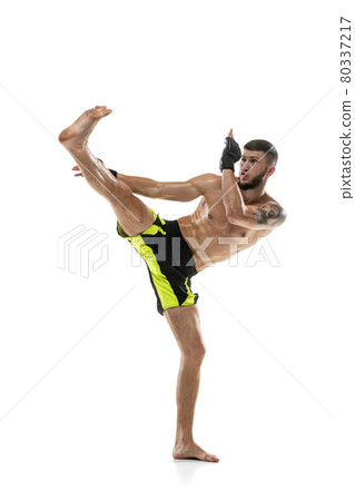 Professional male MMA boxer in motion isolated on white studio background. Fit muscular caucasian athlete fighting. 80337217