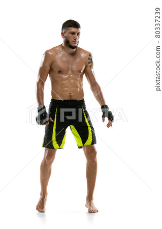 Full-length portrait of Caucasian athlete, professional male MMA boxer isolated on white studio background. Sport, competition and human emotions concept. Full-length portrait of Caucasian athlete, professional male MMA boxer isolated on white studio background. Sport, competition and human emotions concept. 80337239