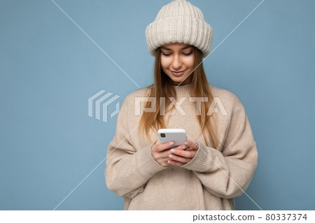 Photo shot of attractive positive good looking young woman wearing casual stylish outfit poising Photo shot of attractive positive good looking young woman wearing casual stylish outfit poising 80337374