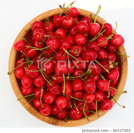Sweet fresh cherries in wooden bowl on white background Sweet fresh cherries in wooden bowl on white background 80337803