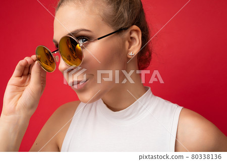 Closeup photo of attractive sad thoughtful angry young blonde woman wearing everyday stylish clothes 80338136
