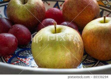 plum, cherry, apple, fruits on color plate plum, cherry, apple, fruits on color plate 80338294