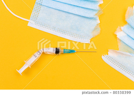 Broken Medical Syringe and Torn Medical Face Mask Broken Medical Syringe and Torn Medical Face Mask 80338399