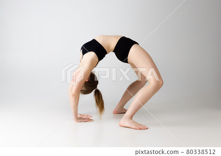 Flexible adorable girl in black lingerie posing isolated over gray studio background. Natural beauty, spa, cosmetics, fitness and aesthetic cosmetology concept. Flexible adorable girl in black lingerie posing isolated over gray studio background. Natural beauty, spa, cosmetics, fitness and aesthetic cosmetology concept. 80338512