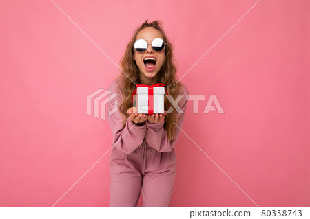 Photo shot of pretty positive surprised young blond woman isolated over colourful background wall Photo shot of pretty positive surprised young blond woman isolated over colourful background wall 80338743