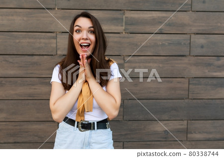 Photo of young emotional positive attractive brunette woman wearing stylish clothes standing in the Photo of young emotional positive attractive brunette woman wearing stylish clothes standing in the 80338744