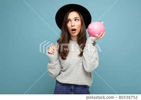 Portrait of astonished amazed young nice attractive woman with dark hair wearing stylish gray 80338752