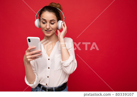 Photo shot of beautiful joyful smiling young female person wearing stylish casual outfit isolated 80339107
