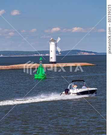 Swinoujscie. The famous old windmill lighthouse on a sunny day. Swinoujscie. The famous old windmill lighthouse on a sunny day. 80339155