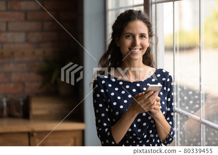 Happy millennial Hispanic woman using online virtual service Happy millennial Hispanic woman using online virtual service 80339455