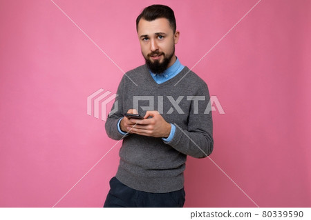 Photo shot of handsome positive good looking young man wearing casual stylish outfit poising 80339590