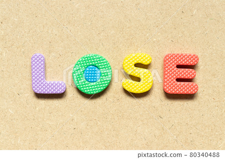 Foam alphabet letter in word lose on wood background Foam alphabet letter in word lose on wood background 80340488