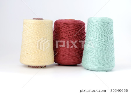 Multicolors bobbins of wool yarn for hand and machine knitting on a white background 80340666