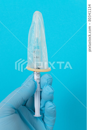 Anti Vaccination Concept - Syringe in a Condom 80341134