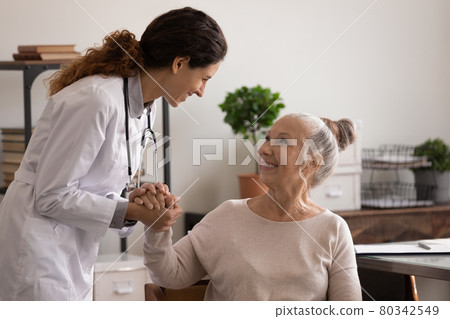 Smiling nurse comfort old female patient in hospital Smiling nurse comfort old female patient in hospital 80342549