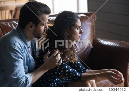 Compassionate husband giving comfort and support to upset wife 80344912