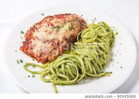 Chicken with parmesan cheese and linguine pasta in pesto sauce Chicken with parmesan cheese and linguine pasta in pesto sauce 80345008