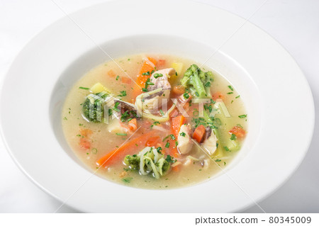 Light fish soup with vegetables and broccoli in white plate. Light fish soup with vegetables and broccoli in white plate. 80345009