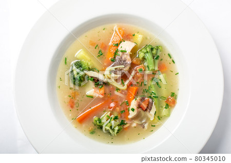 Light fish soup with vegetables and broccoli in white plate. Light fish soup with vegetables and broccoli in white plate. 80345010