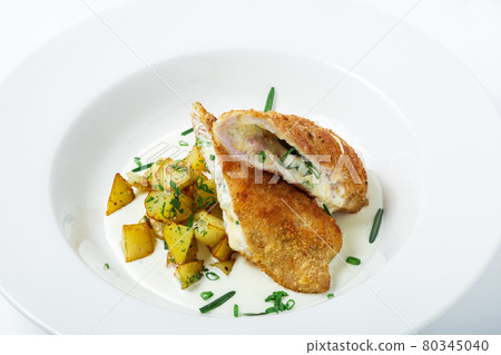 Cutting cordon bleu with cheese, turkey, crackers crumbs, potatoes. Cutting cordon bleu with cheese, turkey, crackers crumbs, potatoes. 80345040